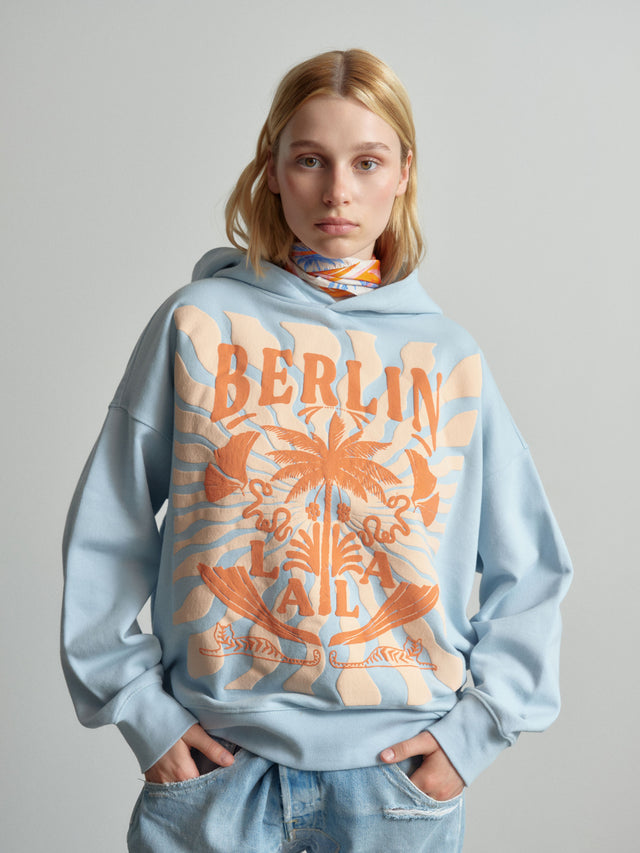 Hoodie Irina sunset palm cashmere blue - The Irina hoodie boasts a relaxed silhouette, providing both style... - 1/2